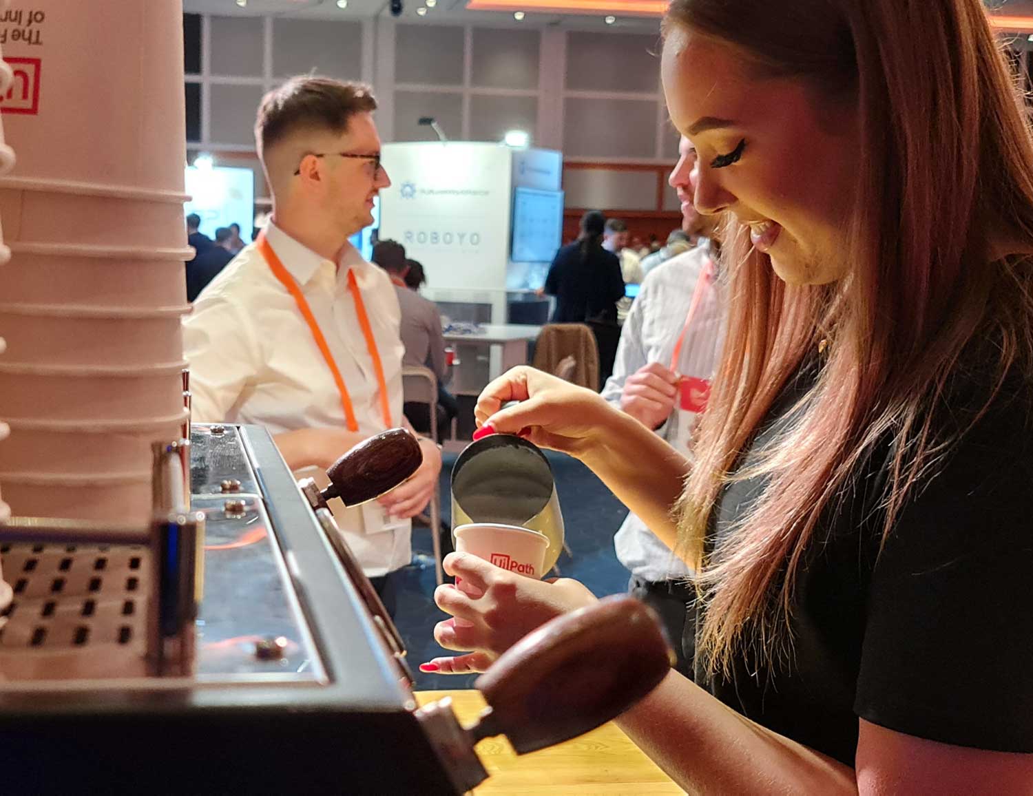 barrista pouring hot milk into coffee on a branded coffee bar for hire