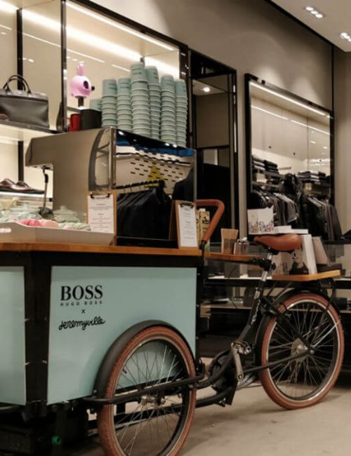 Coffee bike inside Hugo boss next to handbags